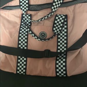 Olivia & Kate blush pink bag that has black/white checkered straps